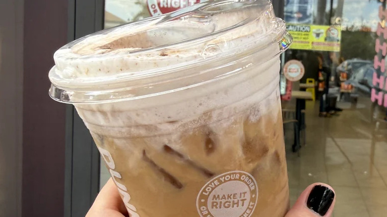 Hand holding cup of Dunkin' Tiramisu Cloud Latte
