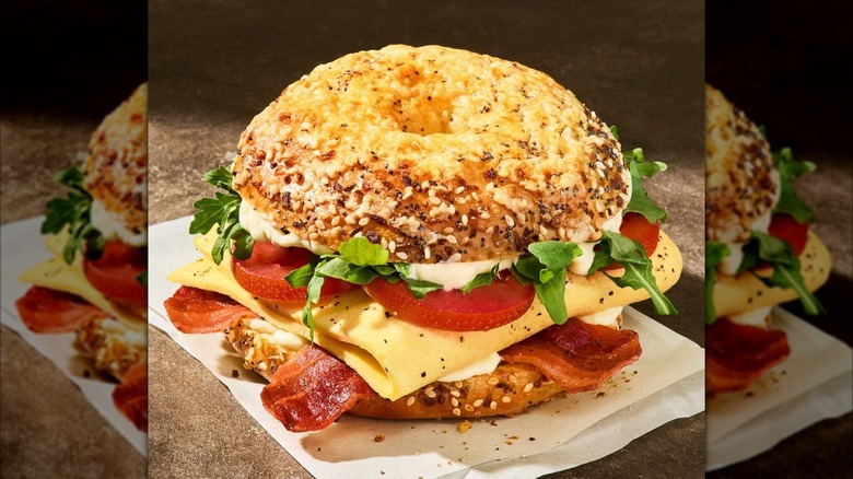 Wake-Up BLT Asiago Everything Bagel Stack sandwich from Panera Bread sitting on white napkin
