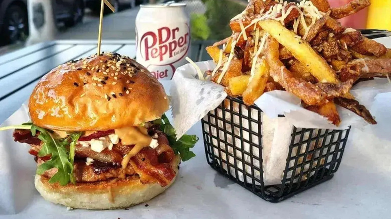 A cheeseburger with a basket of fries at Brgrbelly