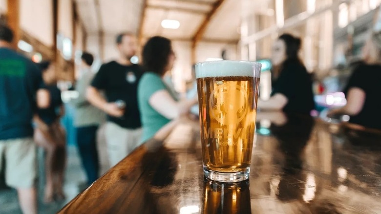 Glass of Melvin Brewing's Method Drop sitting on wooden bar