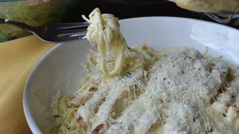 close up of a fork in a cheesy Never-Ending Pasta Bowl from Olive Garden