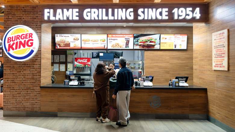 Two customers making an order in a Burger King store