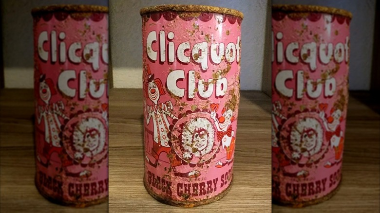 Vintage pink can of Clicquot Club black cherry-flavored soda on wood surface