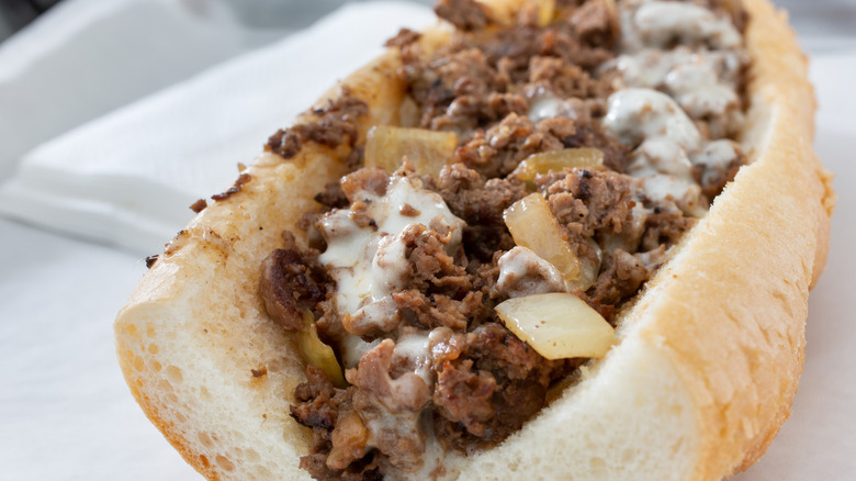 A closeup view of a Philly cheesesteak with onions