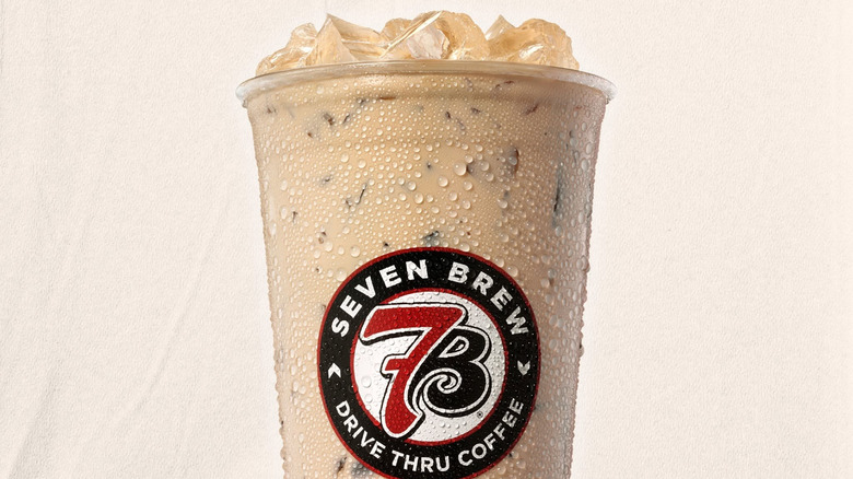 7 Brew Coffee Blondie iced coffee drink in clear plastic cup with condensation and 7 Brew logo on outside