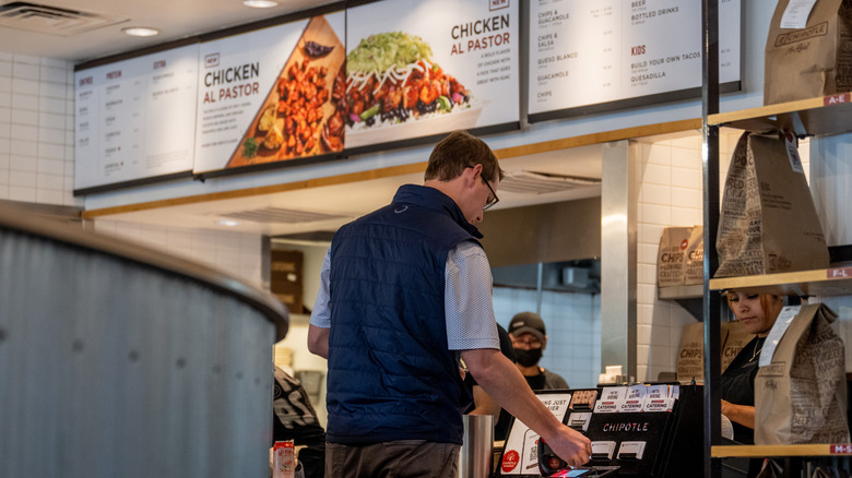 Person picking up mobile order at Chipotle Mexican Grill