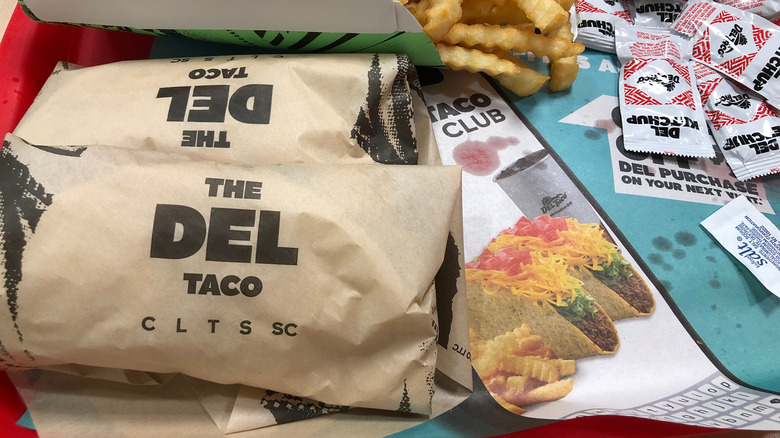 Wrapped tacos on a tray at Del Taco