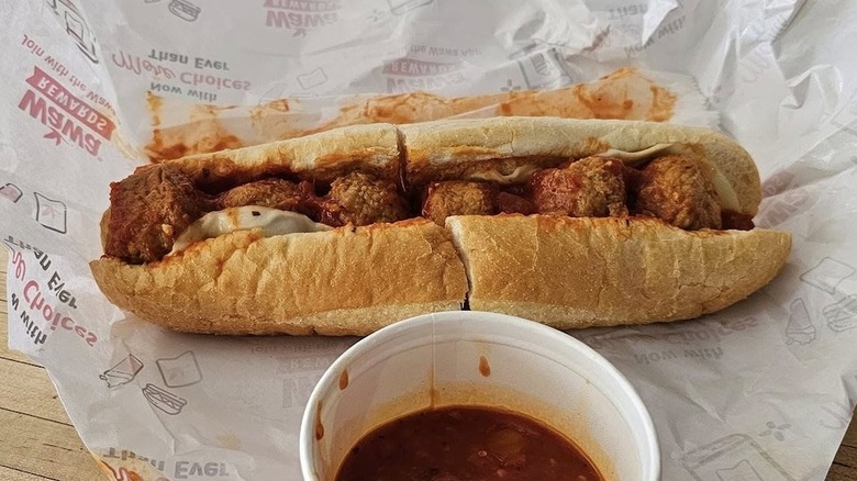 A Wawa meatball sub with a side of marinara sauce
