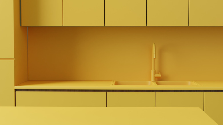 Monochromatic kitchen with yellow countertops, cabinets and sink