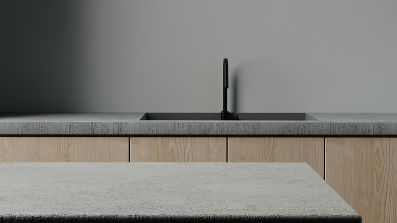 Concrete countertop with wooden cabinets in modern kitchen