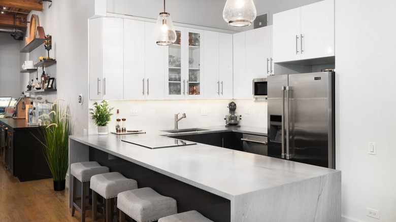 Luxury kitchen with grey kitchen island with waterfall edge