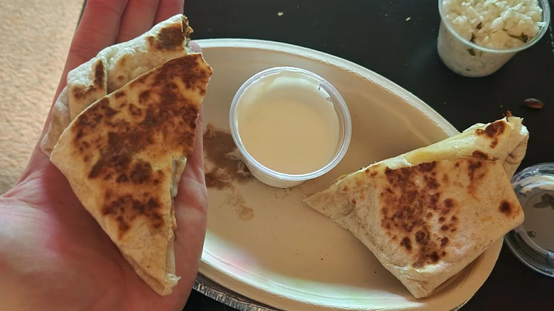 Someone holding a Chipotle quesadilla in their hand