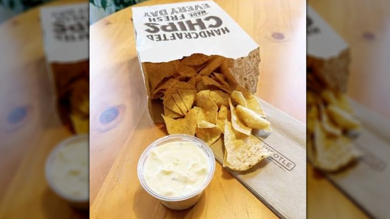 Bag of chips from Chipotle with queso
