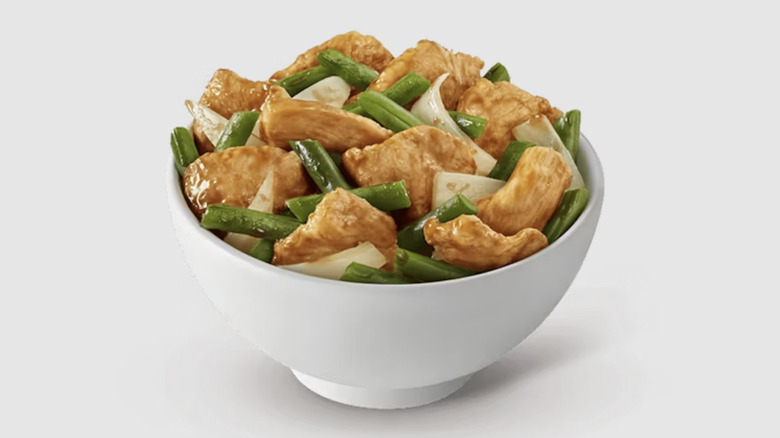 String Bean Chicken Breast in a white bowl on white background