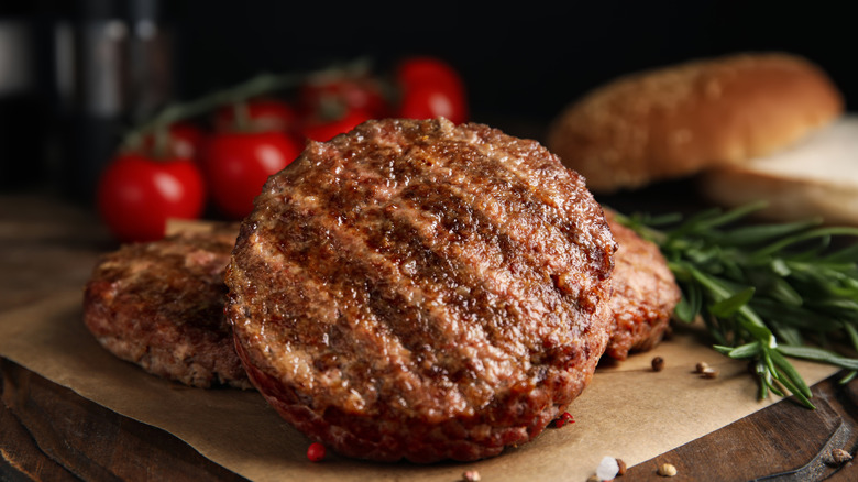 A juicy burger patty sitting on butcher paper