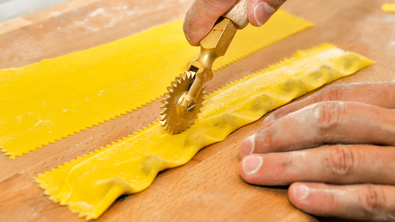Rotary cutter running over a sheet of agnolotti del plin