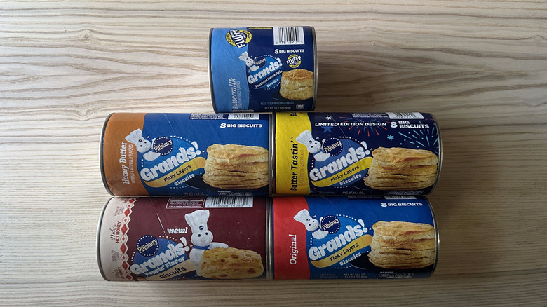Cans of Pillsbury Grands! biscuits on wooden table