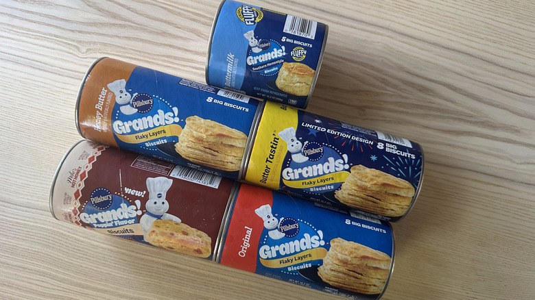 Cans of Pillsbury Grands! biscuits on wooden table