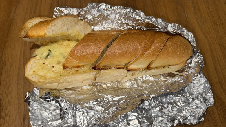 Famous Famiglia Garlic Bread with Mozzarella wrapped in tin foil.