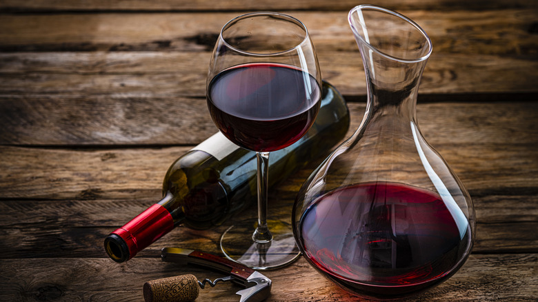 Red wine poured into decanter, indicating high end