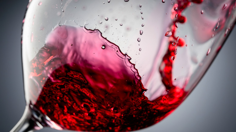 Close up of red wine swirl inside glass