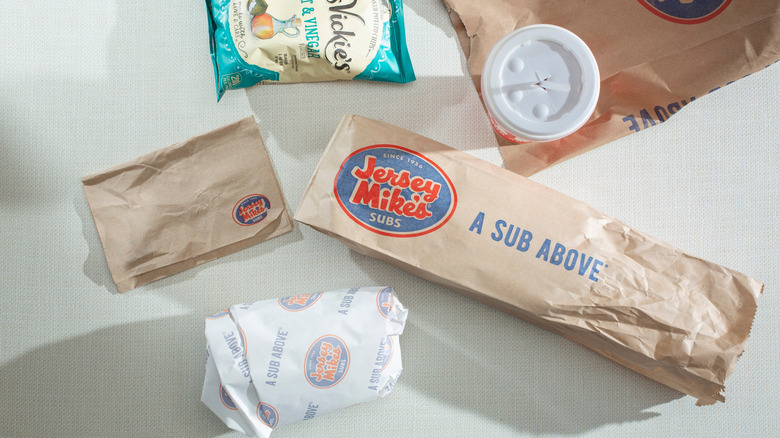 Jersey Mike's sub, drink, napkins, and a bag of chips from above