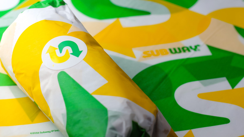Wrapped sandwich from Subway on branded papers