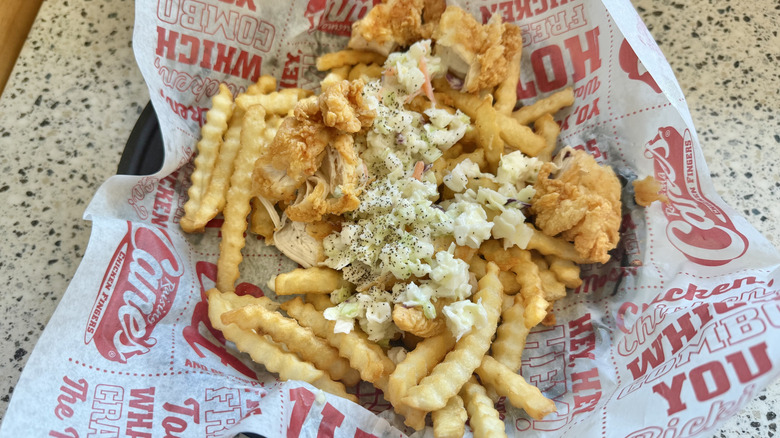 Loaded fries with coleslaw, chicken, pepper, and lemon