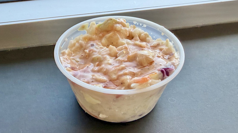 small plastic container of Raising Cane's coleslaw