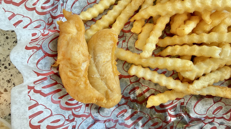 Naked chicken tenders on a tray with oil