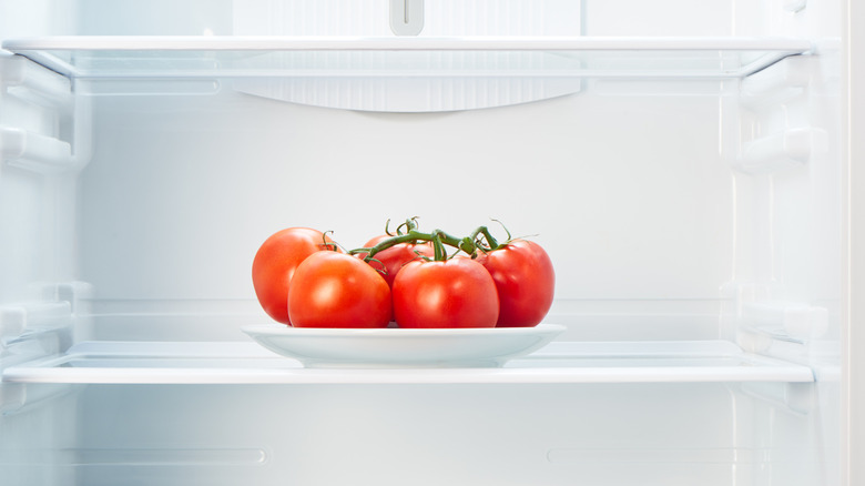 A cluster of tomatoes pictured inside an empty fridge