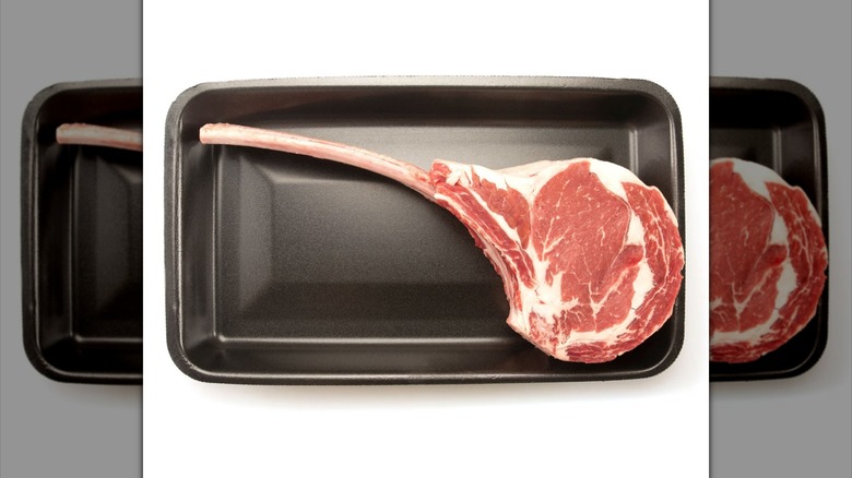 Sam's Club Member's Mark cowboy ribeye steak with bone on top of black tray