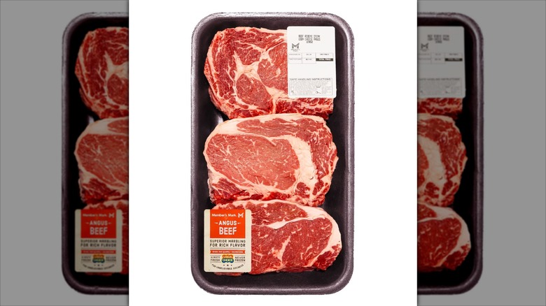 Three Sam's Club Member's Mark brand boneless ribeye steaks in labeled packaging