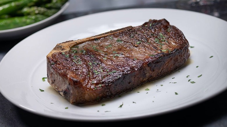18 ounce Bone-In USDA Prime NY Strip on a plate