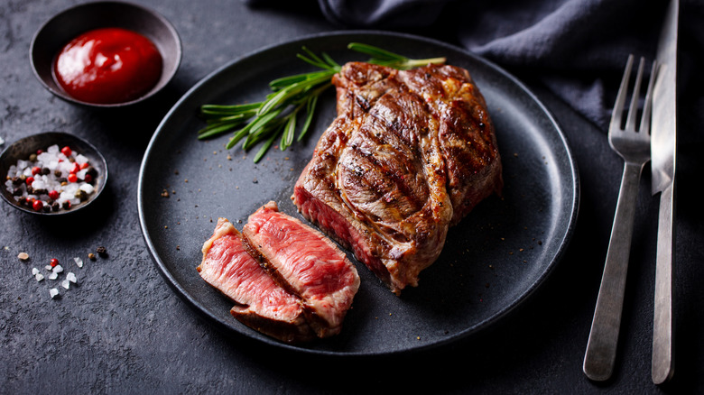 Beef steak medium rare on a black plate