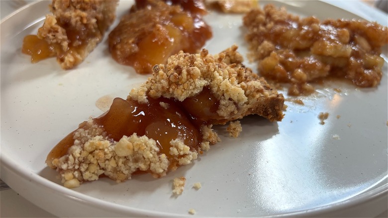 Close-up of pieces of apple pie on white plate
