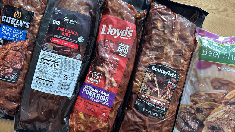 Packaged prepared ribs on wooden table