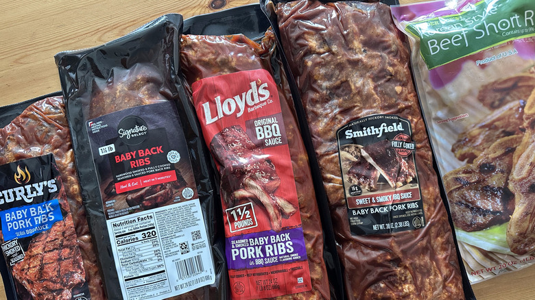 Packaged prepared ribs on wooden table