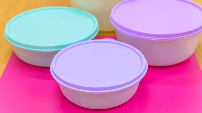 Colorful plastic food storage containers and lids on a kitchen counter