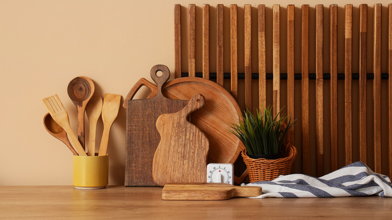 Wooden cutting boards and kitchen utensils arranged on a kitchen counter