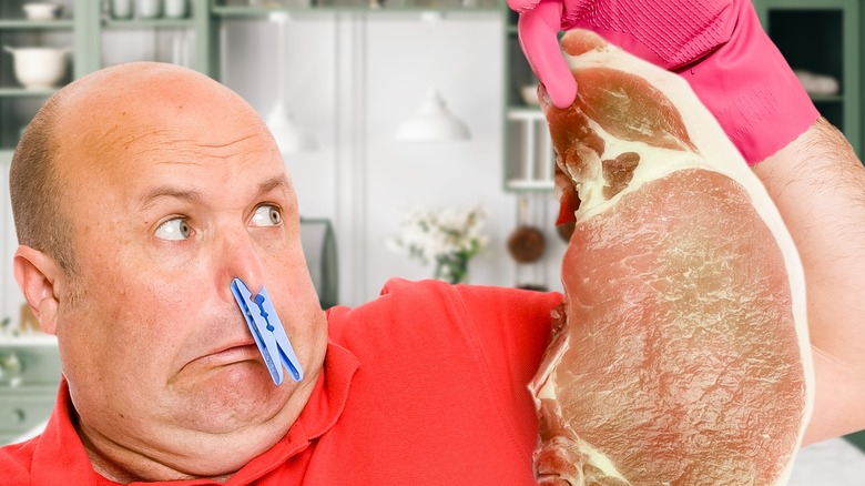 A man holding up pork