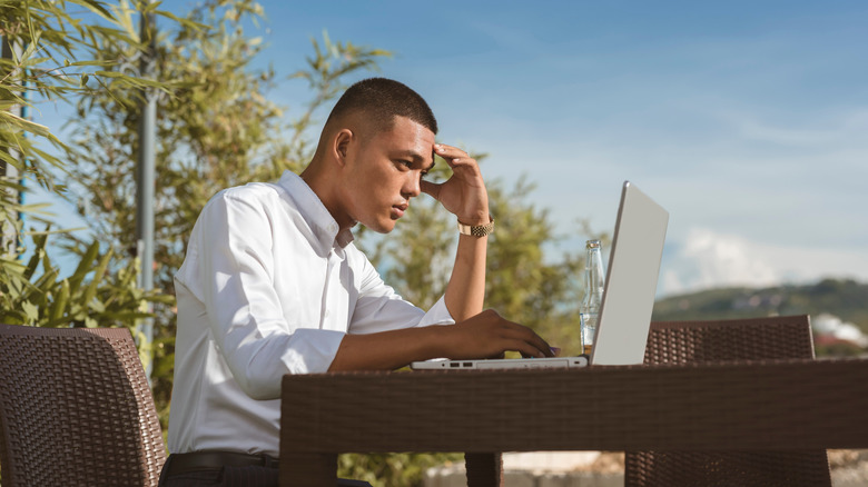 stressed out guy using laptop