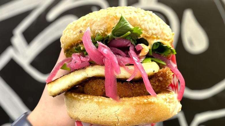 hand holding chicken Cemita sandwich