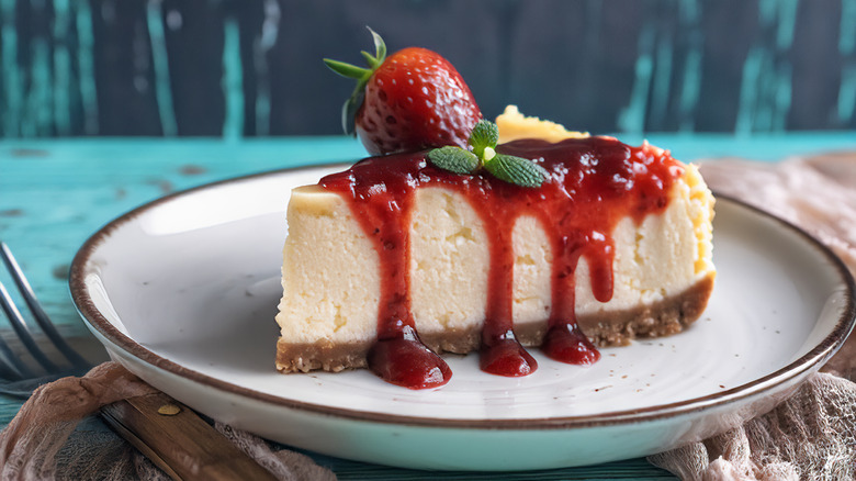 Slice of New York cheesecake with strawberry topping