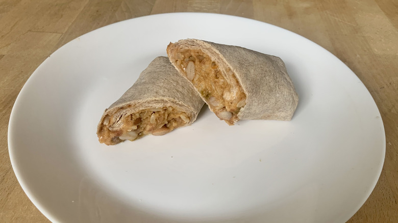 Amy's Bean and Cheeze Burrito cut in half on white plate