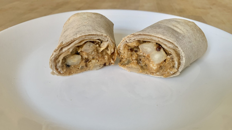 Amy's Breakfast Ranchero Burrito cut in half on white plate