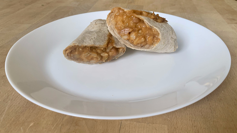 Amy's Bean and Cheese Burrito cut in half on white plate