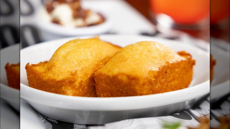 Two mini loaves of cornbread on plate
