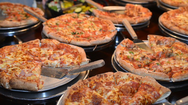 Several pizzas at a buffet