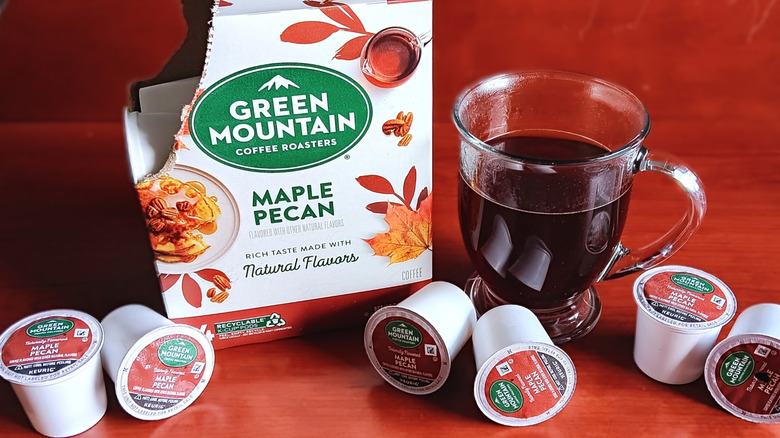 Open box of Green Mountain Maple Pecan flavored coffee K-cups with mug of black coffee